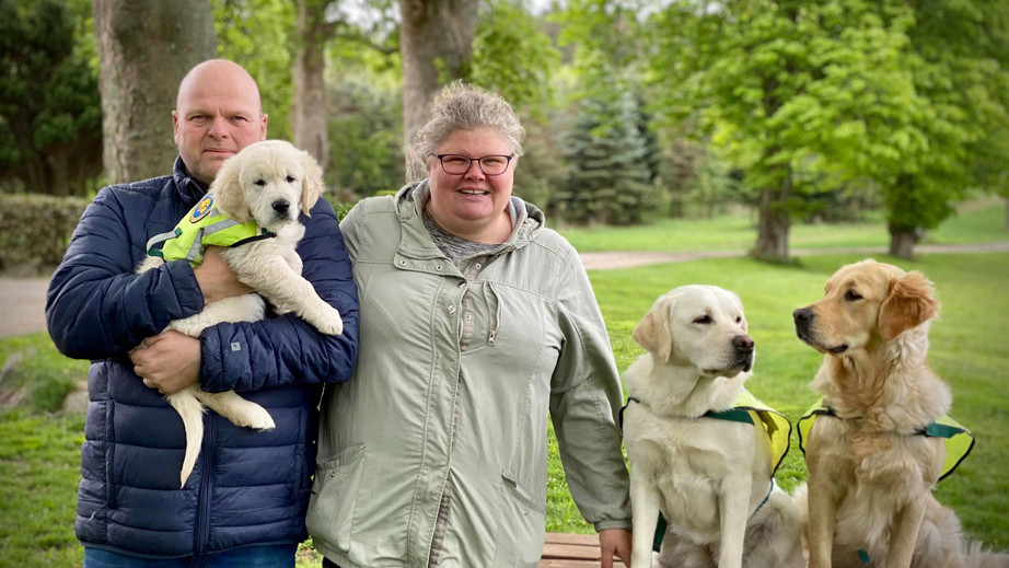 Familie med servicehunde og hvalpeaspirant